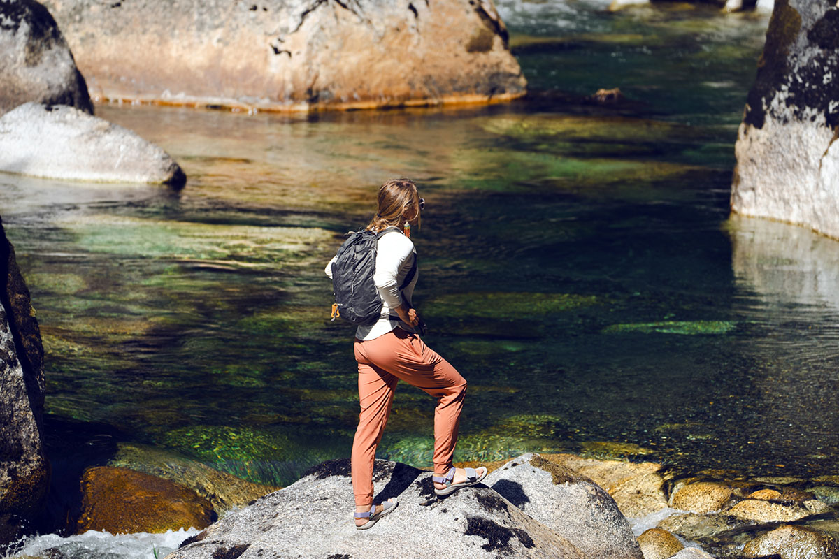 Women's hiking daypacks (standing on rock with REI Flash 18)